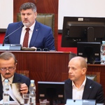 mężczyzna siedzący za biurkiem pracuje